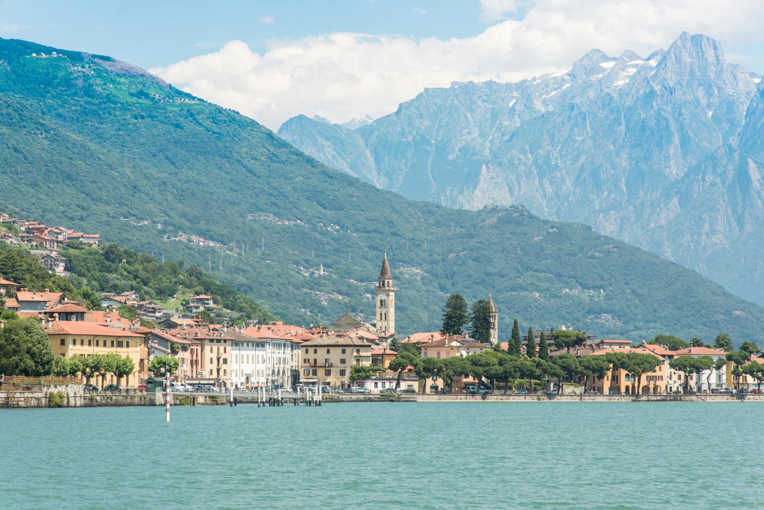 Stunning view of Lake Como's charming town against the backdrop of Italian Alps, Lombardy region.